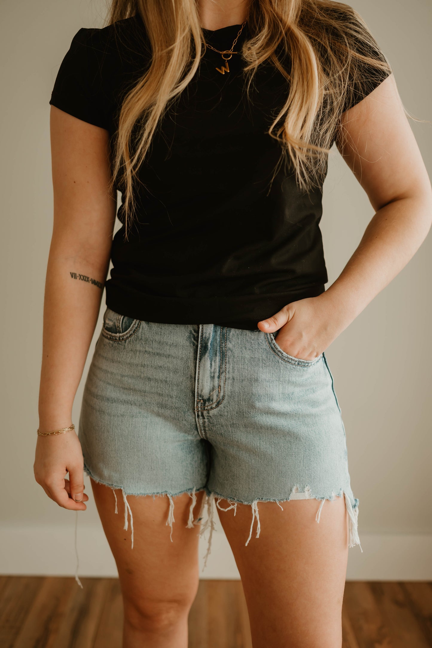 DISTRESSED LIGHT DENIM SHORTS